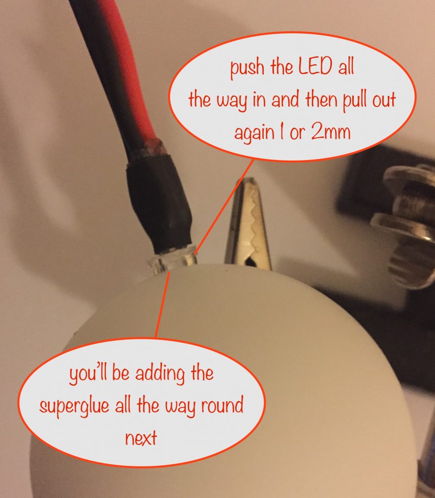 photo showing preparation to superglue the LED to the ping pong ball