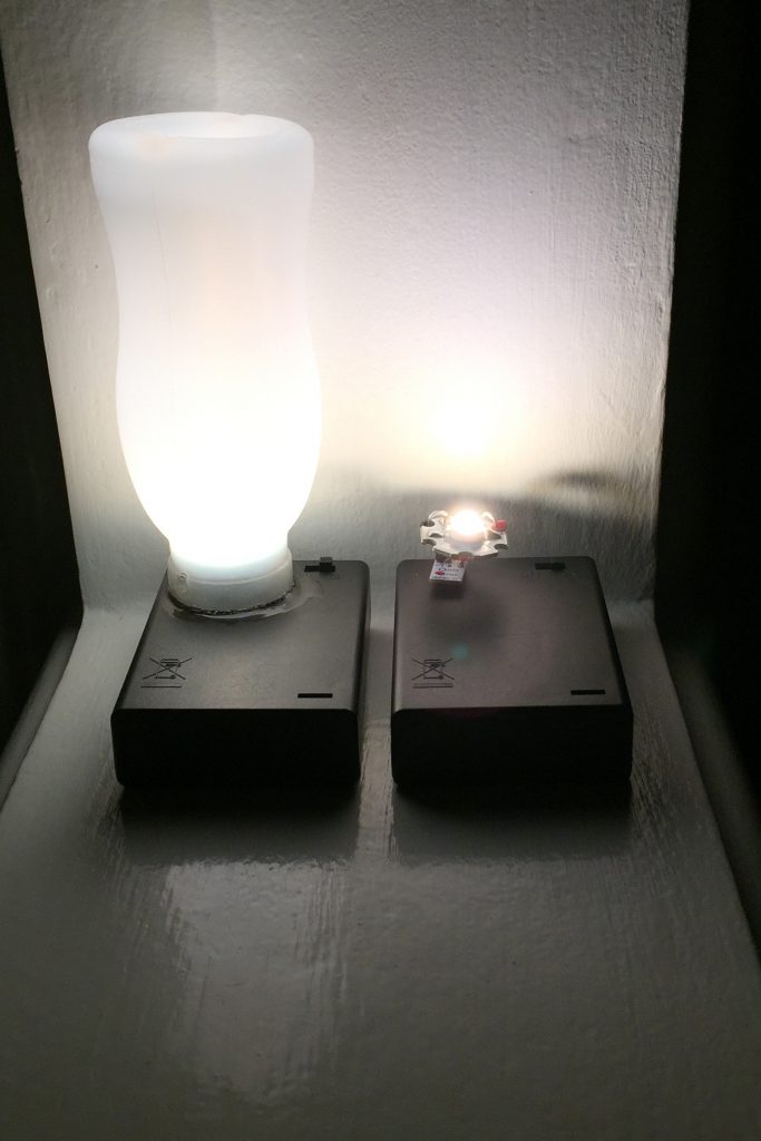 a photo showing the finished mini lamp beside one that's almost finished which shows the LED module in place
