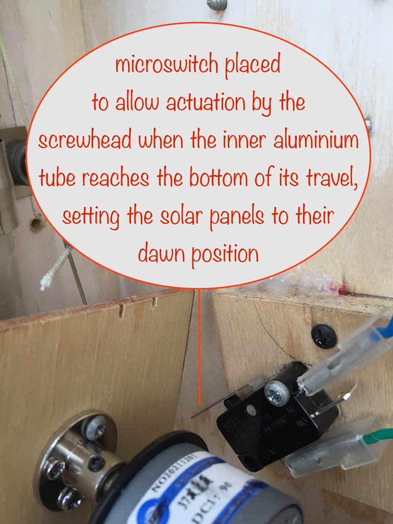photo showing the positioning of the microswitch so the screwhead actuates it at the time when the solar panels have reached their dawn starting position